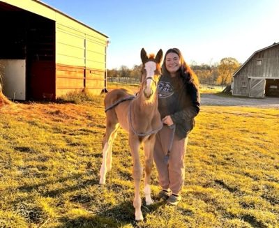 Sofia Killar with a foal in a field