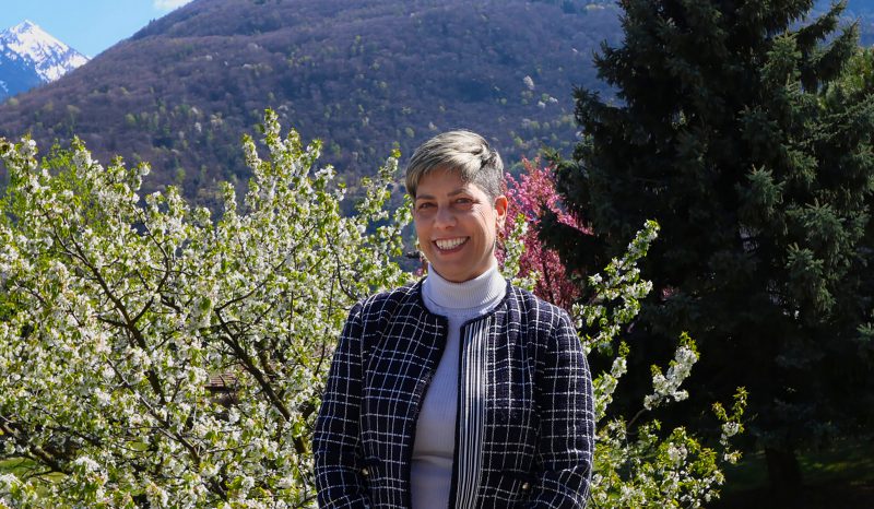 Sara Steinert Borella standing in front of a mountain